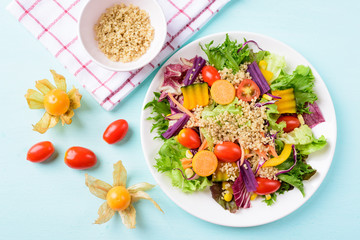 Healthy vegetables salad with quinoa seed and cape gooseberry fruit
