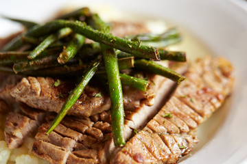 Pork steak and grilled common bean