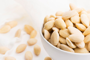 Bowl of almonds on a white background