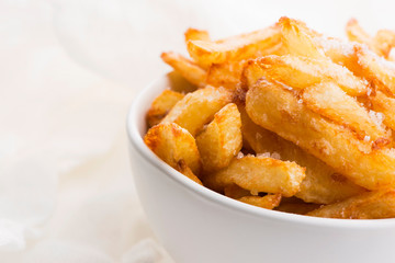 Bowl of potatoe fries on a white background