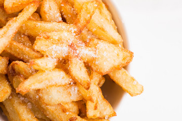 Bowl of potatoe fries on a white background
