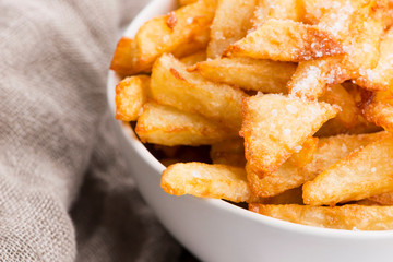 Bowl of potatoe fries on a white background