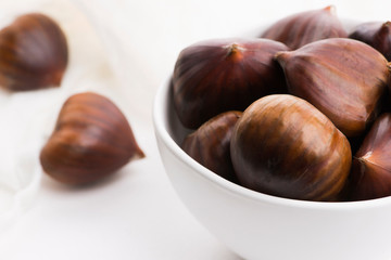 Bowl of chestnuts on a white background