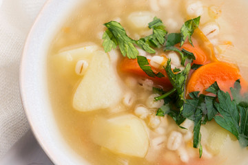 Barley soup, pearl barley in white bowl