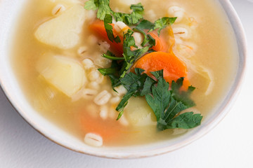 Barley soup, pearl barley in white bowl