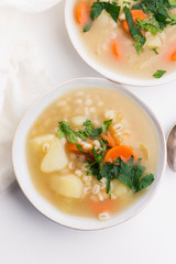 Barley soup, pearl barley in white bowl