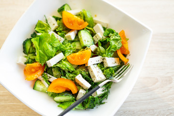 Fresh salad with cheese and tomatoes