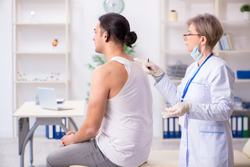 Fototapeta premium Young patient visiting doctor in hospital