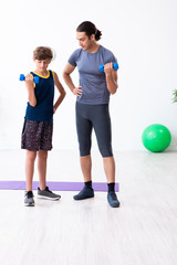 Young father and his son doing exercises