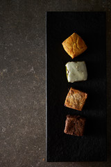 Small square sweet bread on black plate