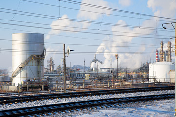   Smoking chimneys of an oil refinery.Horizontally.