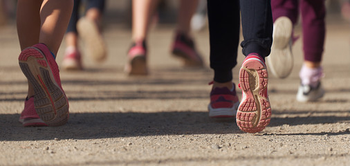 Running children, young athletes run in a kids run race,running on city road detail on legs