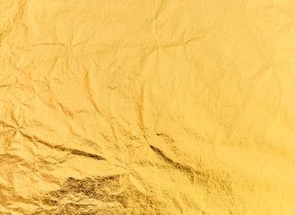 Imitation gold leaf texture background image. Close-up shot with details.