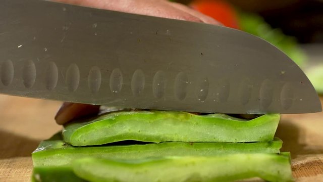 Latin Woman cutting nopales in the kitchen