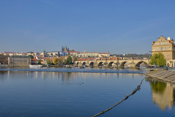 Obraz premium Scenic panorama with Prague Castle (Prazsky hrad), Charles bridge (Karluv most) and Vlatva river in capital of Czech Republic Prague. Beautiful summer sunny cityscape of the biggest city of Czechia