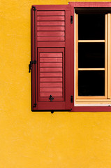 contrast between red window open on yellow wall