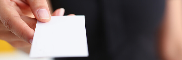 businesswoman give her business card to her new partner closeup