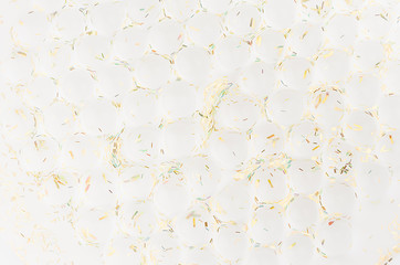 White soft light texture of heap transparent balls with golden glitter as elegant modern holiday abstract background.