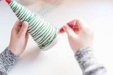 Making Christmas tree . Original children's art project. DIY concept. Step-by-step,instructions. Selective focus.Making xmas toys decoration. Merry Christmas and Happy New Year decoration. Handmade