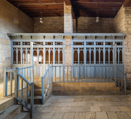 Changing rooms with blue wooden door shutters and wooden balustrades at abandoned historical traditional Turkish public bathhouse, Moez Street, Cairo, Egypt