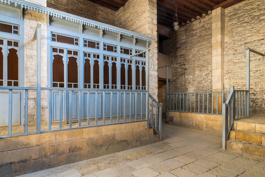 Changing rooms with blue wooden door shutters and wooden balustrades at abandoned historical traditional Turkish public bathhouse, Moez Street, Cairo, Egypt