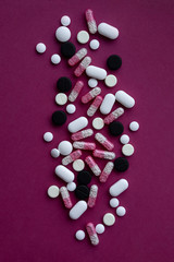 Pills and capsules on purple background. Various Pills.