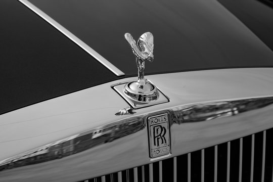 Front View Of Emblem Spirit Of Ecstasy Of New A Very Expensive Rolls Royce Phantom Car, A Long Black Limousine, Model Outdoors On Parking
