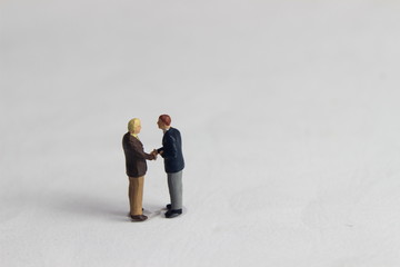 Gray Backgrond, Simple Illustration Photo for Mini Figure Two Man Toy Handshaking for Business Agreement 