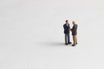 Gray Backgrond, Simple Illustration Photo for Mini Figure Two Man Toy Handshaking for Business Agreement 