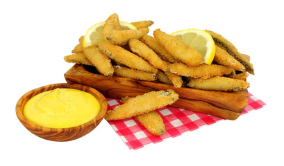 Fried bread crumb covered whitebait fish with mayonnaise dip in an olive wood dish isolated on a white background