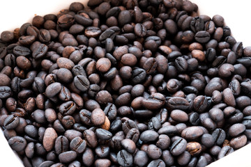 brown and black roasted arabica coffee baens. mashed roasted coffee beans is ingredients of espresso, cappuccino, latte, mocha, americano. coffee is favorite beverage at morning and afternoon break