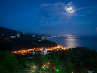The city on the sea coast, at sunset and almost in the darkness of the night