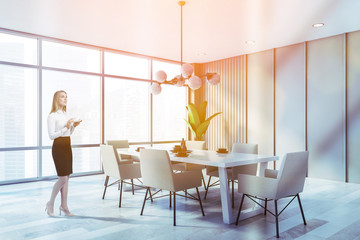 Blonde woman in beige dining room