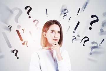 Pensive young woman with many questions