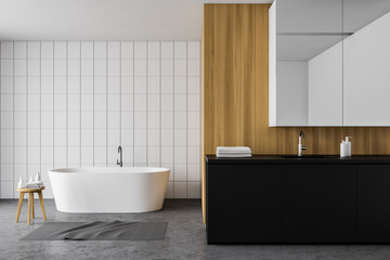 White tile and wood bathroom, tub and sink