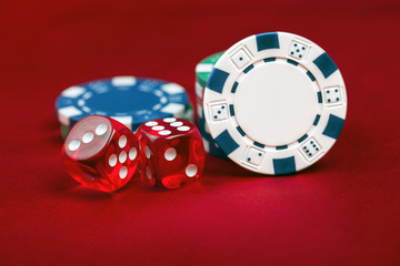 Dices and casino chps on red background