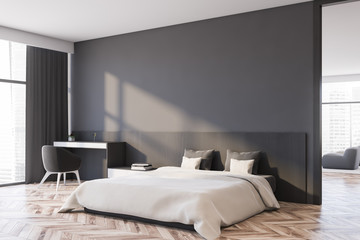 Gray master bedroom corner with armchair