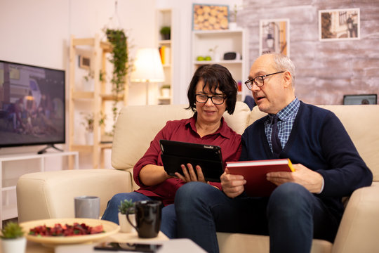 Beautiful old couple using a digital tablet to chat with their family