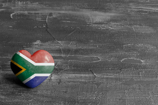 South African flag on a heart on a rustic background