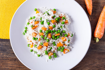 Basmati rice with carrots and green peas. View from the top.