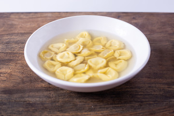 Tortellini in broth. Italian traditional dish. Winter food
