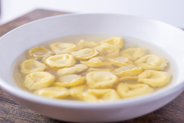 Tortellini in broth. Italian traditional dish. Winter food. Close up view