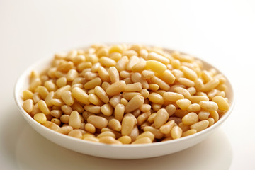 Pine nuts on white plate 