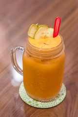 fruit juice mixture of Carrot, Apple and Ginger served in a tall glass
