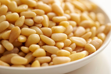 Pine nuts on white plate 