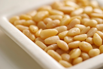 Pine nuts on white plate 