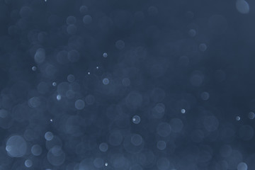 abstract sparkle bokeh light effect with navy blue background