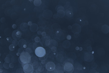 abstract sparkle bokeh light effect with navy blue background