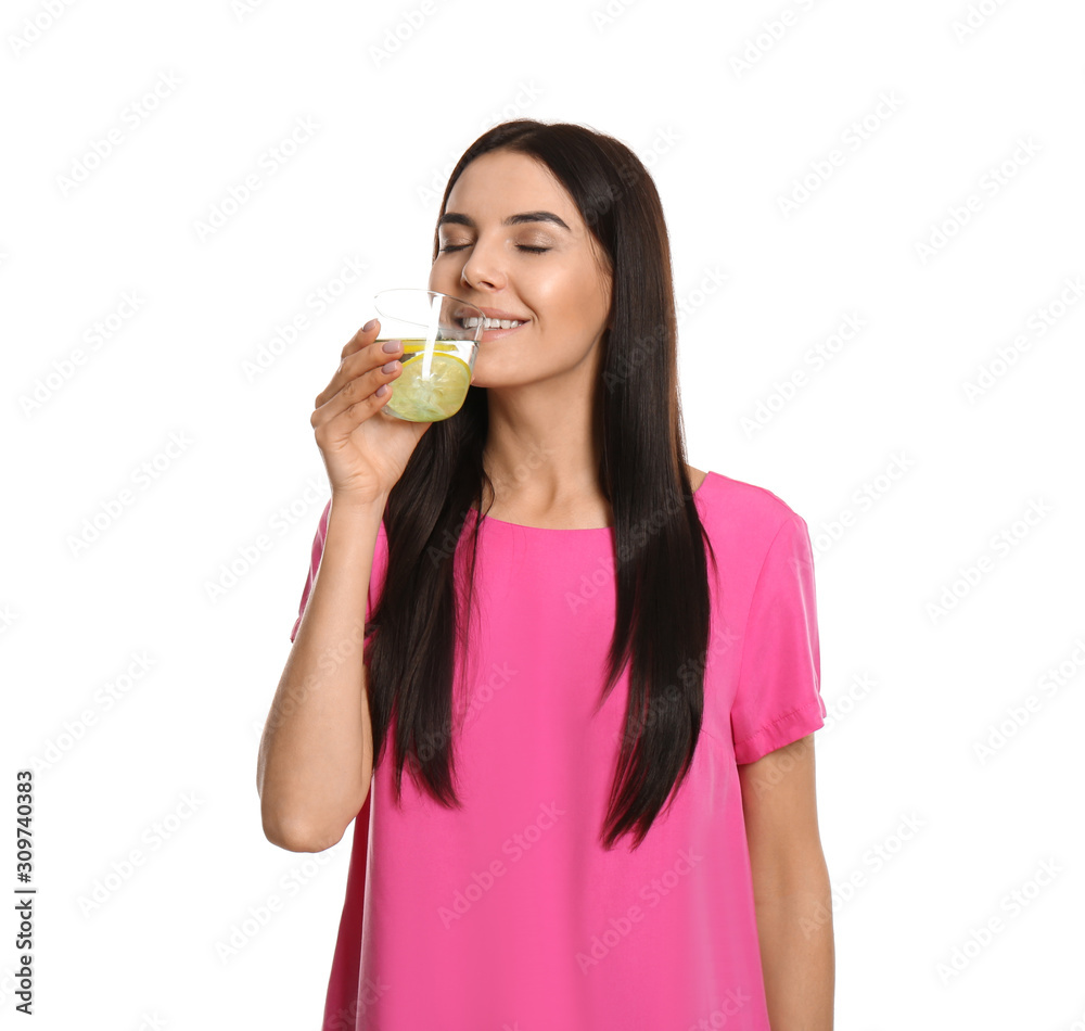 Sticker Beautiful young woman drinking tasty lemon water on white background