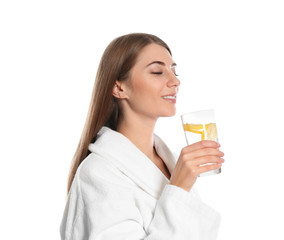 Young woman drinking lemon water on white background